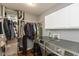 Laundry room featuring modern washer and dryer, storage cabinets, and a hanging rack at 7775 N Kitchen Rd, Mooresville, IN 46158
