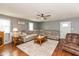 Inviting living room with ample seating, hardwood floors, and natural light streaming through the windows at 7775 N Kitchen Rd, Mooresville, IN 46158