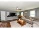 Spacious living room with hardwood floors, large sectional sofa, and a mounted TV at 7775 N Kitchen Rd, Mooresville, IN 46158