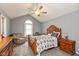 Spacious main bedroom with vaulted ceilings, ceiling fan, and a large decorative wood bed frame at 7775 N Kitchen Rd, Mooresville, IN 46158