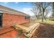 Wooden deck with benches and brick patio at 7817 Dartmouth Rd, Indianapolis, IN 46260