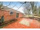 Brick patio, deck, and mature trees in backyard at 7817 Dartmouth Rd, Indianapolis, IN 46260