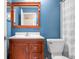 Clean bathroom with wood vanity and shower/tub combo at 7817 Dartmouth Rd, Indianapolis, IN 46260
