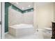 Bathroom with corner bathtub, tile surround and vanity at 7817 Dartmouth Rd, Indianapolis, IN 46260