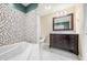 Updated bathroom with a soaking tub and dark vanity at 7817 Dartmouth Rd, Indianapolis, IN 46260