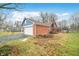 Exterior shot of a red brick house with a white garage door and blue siding at 7817 Dartmouth Rd, Indianapolis, IN 46260