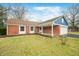 Brick ranch home with a blue accent and attached garage at 7817 Dartmouth Rd, Indianapolis, IN 46260