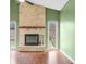 Brick fireplace with wood mantel in living room at 7817 Dartmouth Rd, Indianapolis, IN 46260