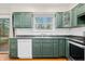 Kitchen with dark green cabinets, stainless steel appliances and hardwood floors at 7817 Dartmouth Rd, Indianapolis, IN 46260
