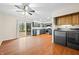 Eat-in kitchen with dark green cabinets, stainless steel appliances, and laminate flooring at 7817 Dartmouth Rd, Indianapolis, IN 46260