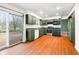Kitchen with dark green cabinets, stainless steel appliances and hardwood floors at 7817 Dartmouth Rd, Indianapolis, IN 46260