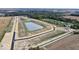 Aerial view of large community with pond and surrounding fields at 7872 Magnolia St, New Palestine, IN 46163