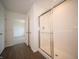 Clean bathroom with a glass-enclosed shower, white trim, and doorway to the bedroom at 7872 Magnolia St, New Palestine, IN 46163