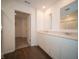 Bright bathroom featuring a double vanity and doorway to the walk-in closet at 7872 Magnolia St, New Palestine, IN 46163
