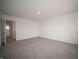 Neutral carpet and light walls create a calm and inviting atmosphere in this spacious bedroom at 7872 Magnolia St, New Palestine, IN 46163