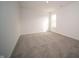 Inviting bedroom featuring plush carpet, white walls and a sunny window at 7872 Magnolia St, New Palestine, IN 46163