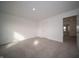 Comfortable bedroom with neutral carpet, white walls, and a doorway leading to another room at 7872 Magnolia St, New Palestine, IN 46163