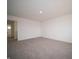 Expansive bedroom with plush carpet, neutral paint, and an open doorway to the rest of the home at 7872 Magnolia St, New Palestine, IN 46163