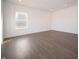 This bedroom has hard surface floors, a window for natural light, and neutral walls to suit any decor at 7872 Magnolia St, New Palestine, IN 46163