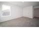 Well-lit bedroom features plush carpet, a large window, and neutral walls, creating a welcoming space at 7872 Magnolia St, New Palestine, IN 46163