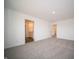 Spacious bedroom with neutral carpet, white walls, and ensuite bathroom access at 7872 Magnolia St, New Palestine, IN 46163