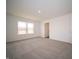 Cozy bedroom with a window, soft carpet, and a door leading to other rooms in the house at 7872 Magnolia St, New Palestine, IN 46163