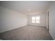 Comfortable bedroom with soft carpet, a bright window, and neutral walls at 7872 Magnolia St, New Palestine, IN 46163