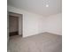 Clean bedroom featuring neutral walls, plush carpet, and a walk-in closet at 7872 Magnolia St, New Palestine, IN 46163