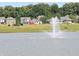 Community view of homes surrounding a pond with a fountain at 7872 Magnolia St, New Palestine, IN 46163