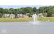 Tranquil community pond with a water fountain and scenic views of houses at 7872 Magnolia St, New Palestine, IN 46163