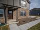 Welcoming front entrance featuring a brown door, brick columns, and a well-maintained sidewalk at 7872 Magnolia St, New Palestine, IN 46163
