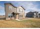 Beautiful two-story home with brown siding, brick, landscaped front, and a neighboring house under a bright sky at 7872 Magnolia St, New Palestine, IN 46163