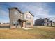 View of a modern two-story home with brown siding, brickwork, and a neatly maintained front yard at 7872 Magnolia St, New Palestine, IN 46163