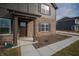 Close-up view of a home's front entry featuring brick pillars and a dark-stained front door at 7872 Magnolia St, New Palestine, IN 46163