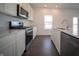 Kitchen featuring stainless steel appliances, sleek countertops, and ample cabinet space at 7872 Magnolia St, New Palestine, IN 46163