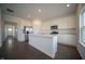 Modern kitchen with stainless steel appliances, white cabinets, and a large kitchen island at 7872 Magnolia St, New Palestine, IN 46163