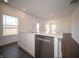 Bright kitchen island features a stainless steel dishwasher, sink, and white countertops at 7872 Magnolia St, New Palestine, IN 46163