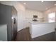 Modern kitchen featuring stainless steel appliances and a large central island with counter seating at 7872 Magnolia St, New Palestine, IN 46163