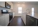 Close-up of the well-equipped kitchen featuring stainless steel appliances, countertops, and modern cabinetry at 7872 Magnolia St, New Palestine, IN 46163