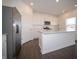 Modern kitchen with stainless steel appliances, island with sink, and white cabinetry offering plenty of storage at 7872 Magnolia St, New Palestine, IN 46163
