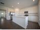 Bright kitchen featuring a large island, stainless steel appliances, and ample storage in white cabinetry at 7872 Magnolia St, New Palestine, IN 46163