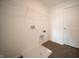 Functional laundry area with hookups and shelving for organized storage at 7872 Magnolia St, New Palestine, IN 46163