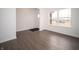 Bright living room with white walls, dark wood floors, and large windows, offering a clean and modern feel at 7872 Magnolia St, New Palestine, IN 46163
