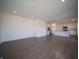 Spacious living room with hard surface floors that flows into the kitchen with modern stainless steel appliances at 7872 Magnolia St, New Palestine, IN 46163