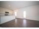 Open-concept living area seamlessly connects to the modern kitchen, with wood flooring and ample space at 7872 Magnolia St, New Palestine, IN 46163