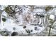 Aerial view of a home on a snow-covered lot with mature trees at 9210 Briarclift Rd, Indianapolis, IN 46256