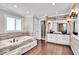 Elegant bathroom with double vanities, a large soaking tub, and modern finishes at 9210 Briarclift Rd, Indianapolis, IN 46256