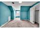Charming bedroom with teal walls and carpet at 9210 Briarclift Rd, Indianapolis, IN 46256