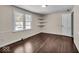 Spacious bedroom with hardwood floors and built-in corner shelves at 9210 Briarclift Rd, Indianapolis, IN 46256