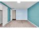 Spacious bedroom with teal and light blue walls and carpet at 9210 Briarclift Rd, Indianapolis, IN 46256